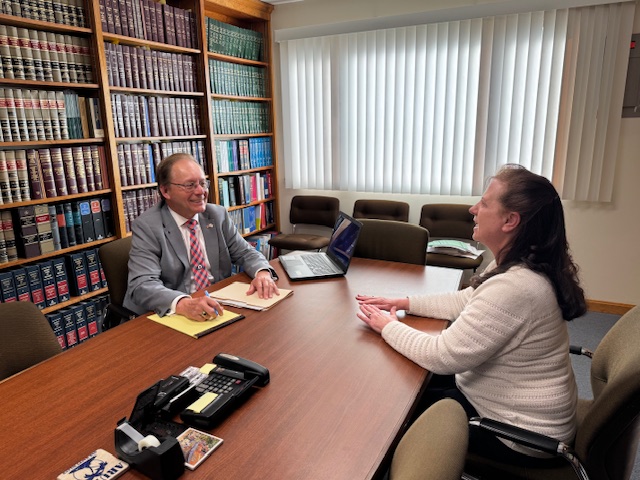 Attorney Jay McMahon conducting a client consultation in his professional Buzzards Bay conference room